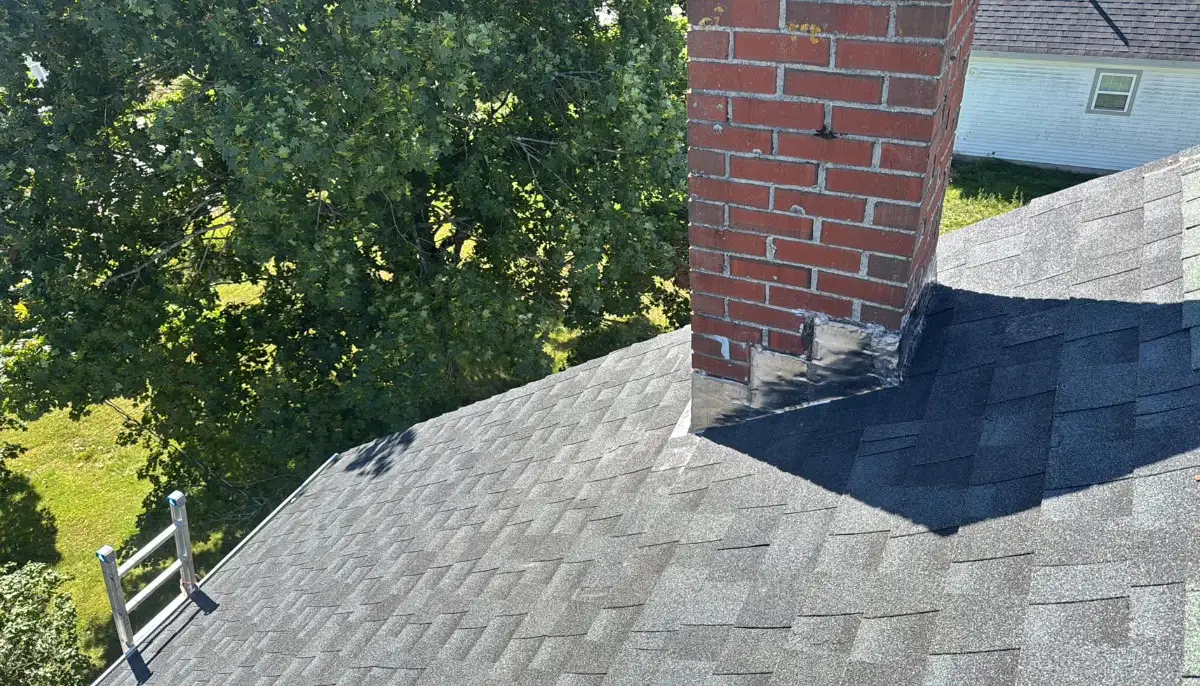 Chimney flashing repair on an asphalt shingle roof