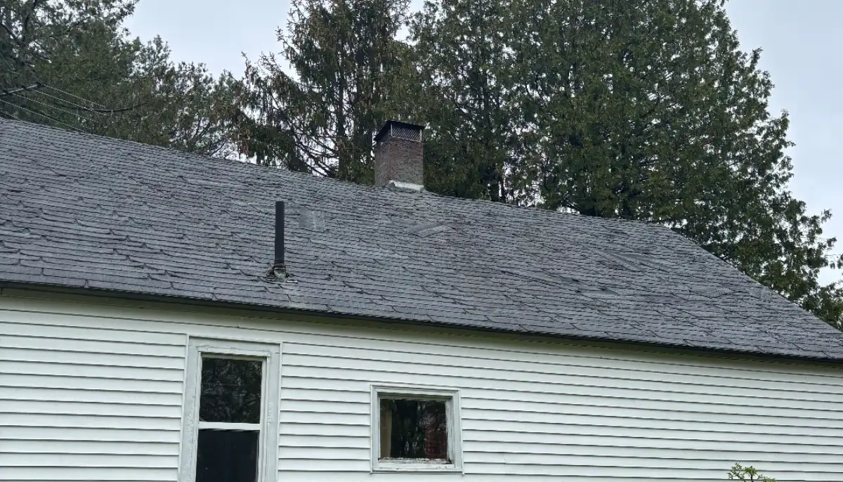Before: storm-worn roof that needed emergency tarping
