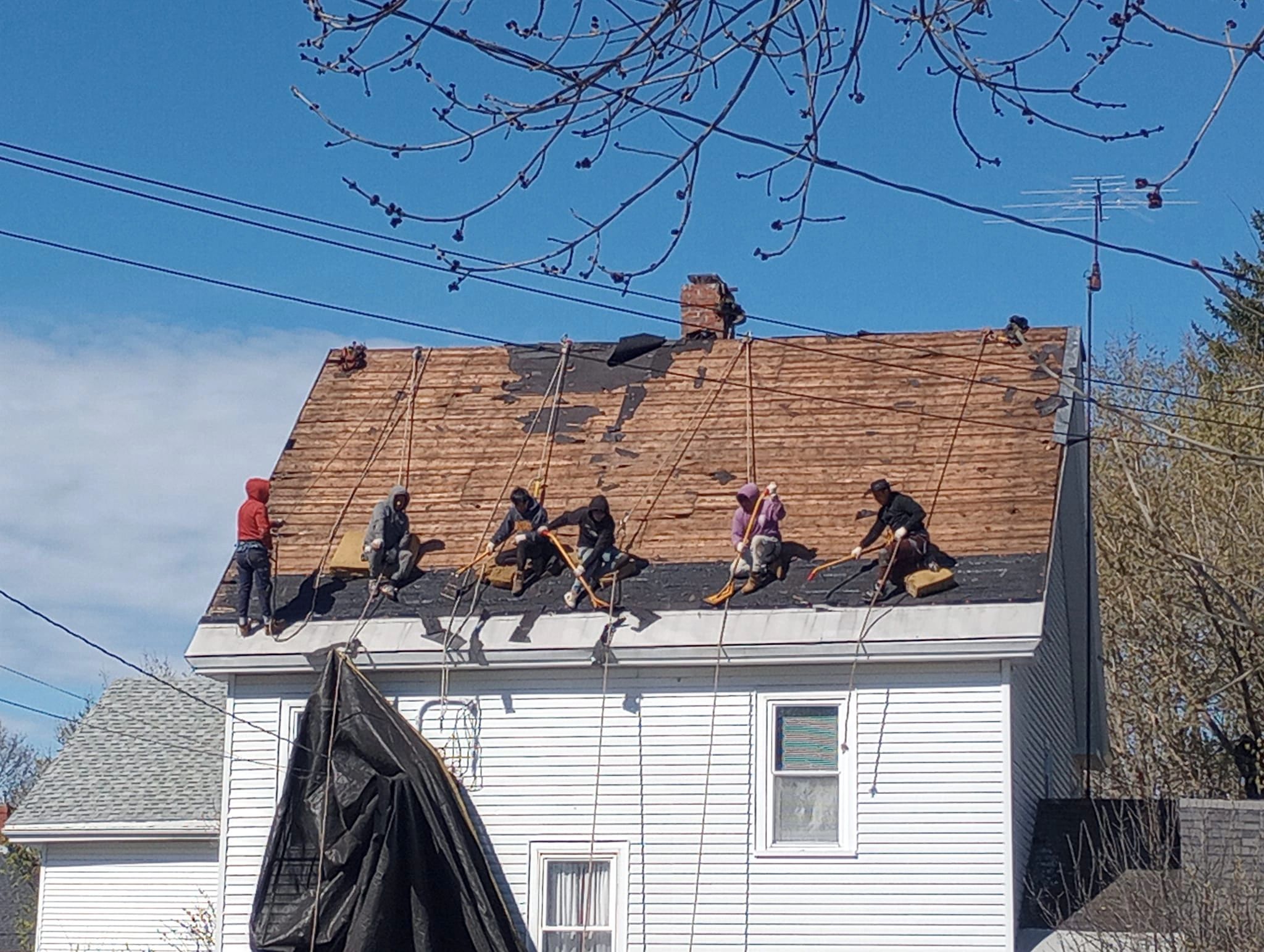 6 Iron Badger Roofing Roofer's stripping an old roof.