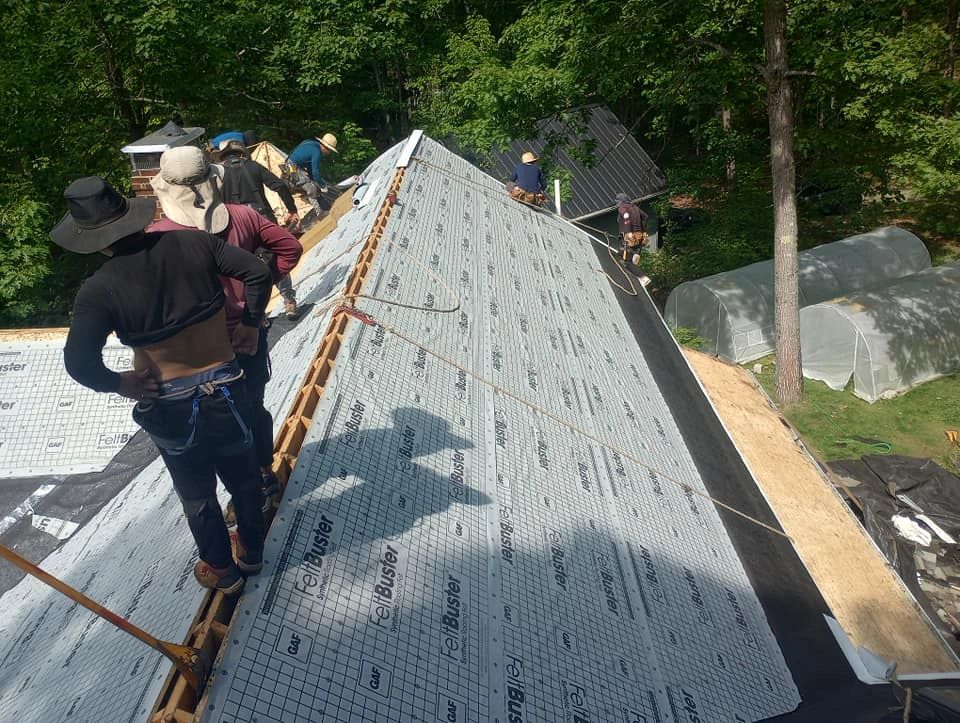 Iron Badger Roofing crew is installing GAF Ice and water shield and GAF synthetic felt paper on a roof.