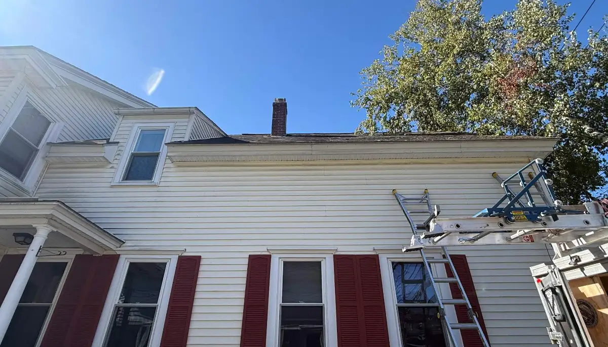 Ladder and roof hoist set up for a roof repair