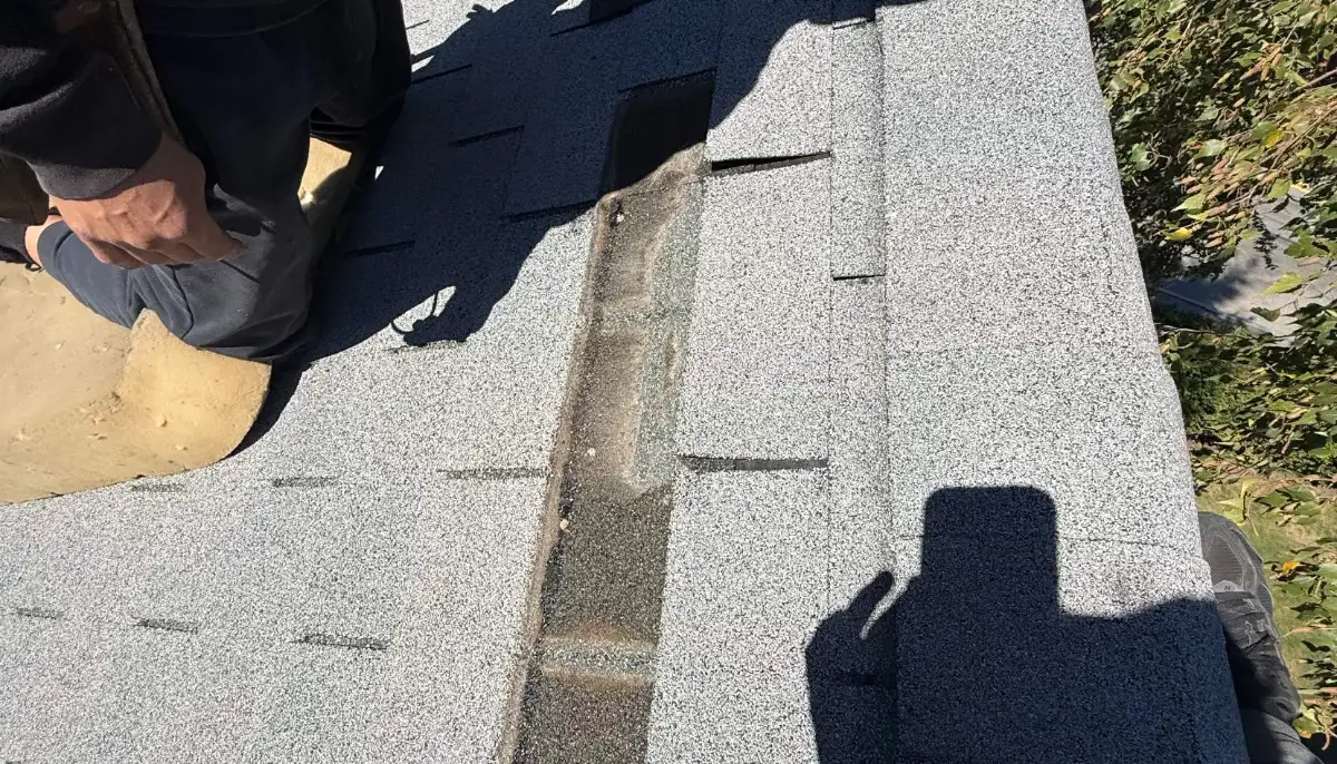 Asphalt shingle ridge being repaired