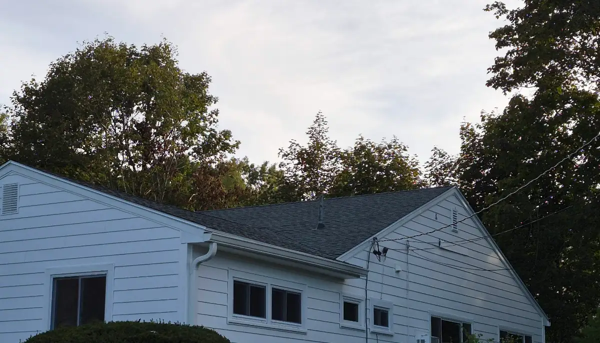 New dark architectural shingle roof on a white ranch home