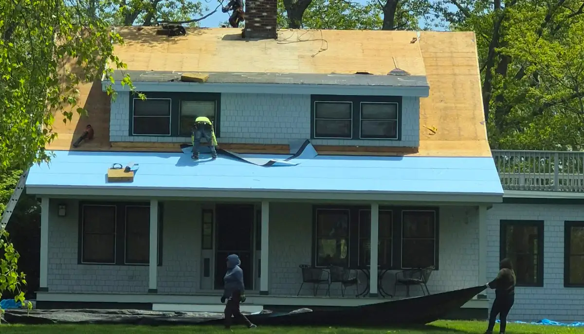Slate roof job in progress: new decking and high-temperature ice and water shield on a dormered Cape